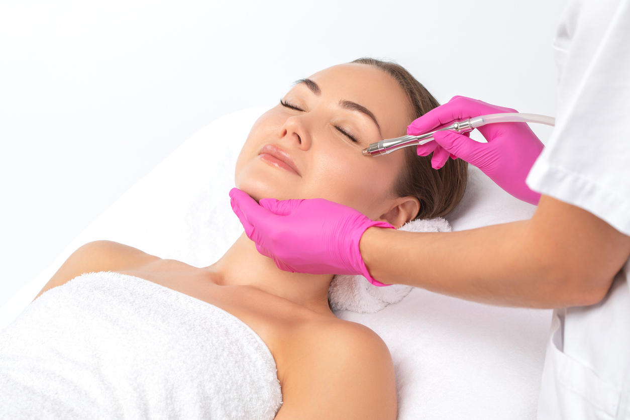 Cosmetologist makes  procedure microdermabrasion on the face against acne and blackheads near the eyes. Women's cosmetology in the beauty salon. HALO AESTHETICS BAR - West Hollywood’s Best-Kept Beauty Secret